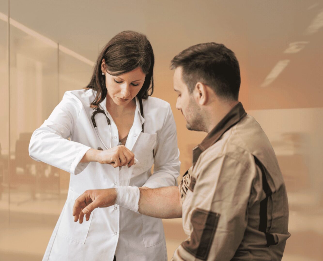 Doctor examines a patient's arm in a clinic.